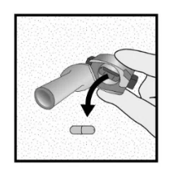 A close-up of a hand holding a pill

Description automatically generated 